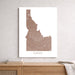 Map of Idaho on a white wall above a wooden shelf.