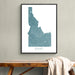 Framed map of Idaho on a wall above a wooden bench.