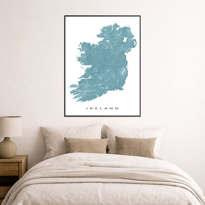 Framed map of Ireland on a wall above a bed in a bedroom.