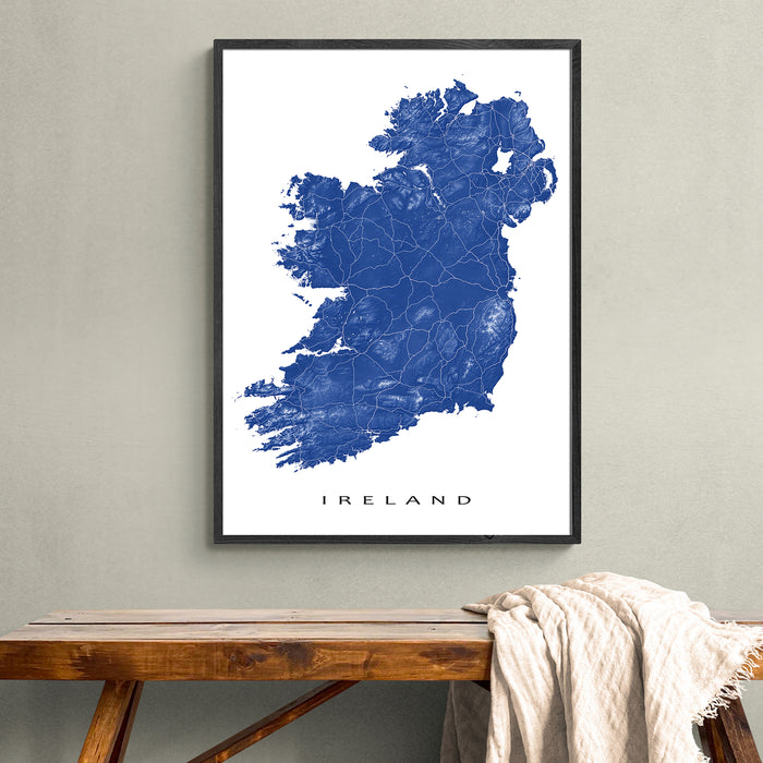 Framed map of Ireland on a wall above a wooden bench.