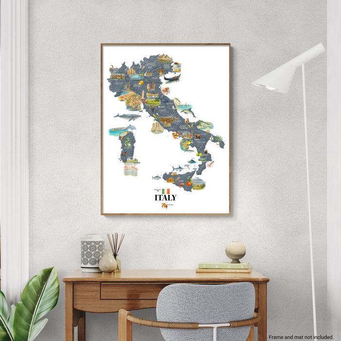 Framed map of Italy on a wall above a desk with decorative items.