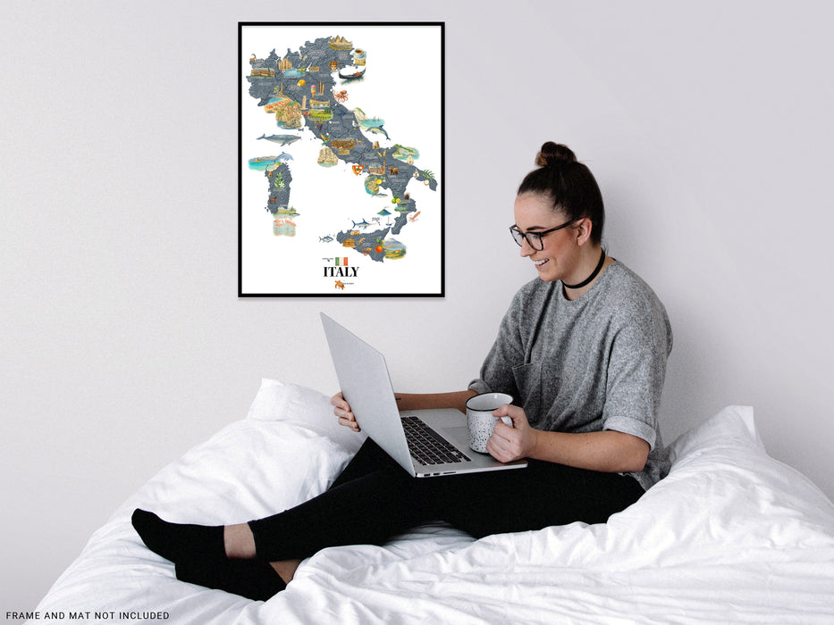 Person sitting on a bed using a laptop with a map of Italy on the wall behind them.