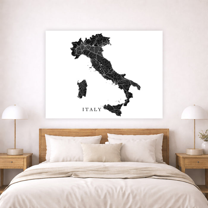 Map of Italy on a wall above a bed in a bedroom setting