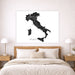 Map of Italy on a wall above a bed in a bedroom setting
