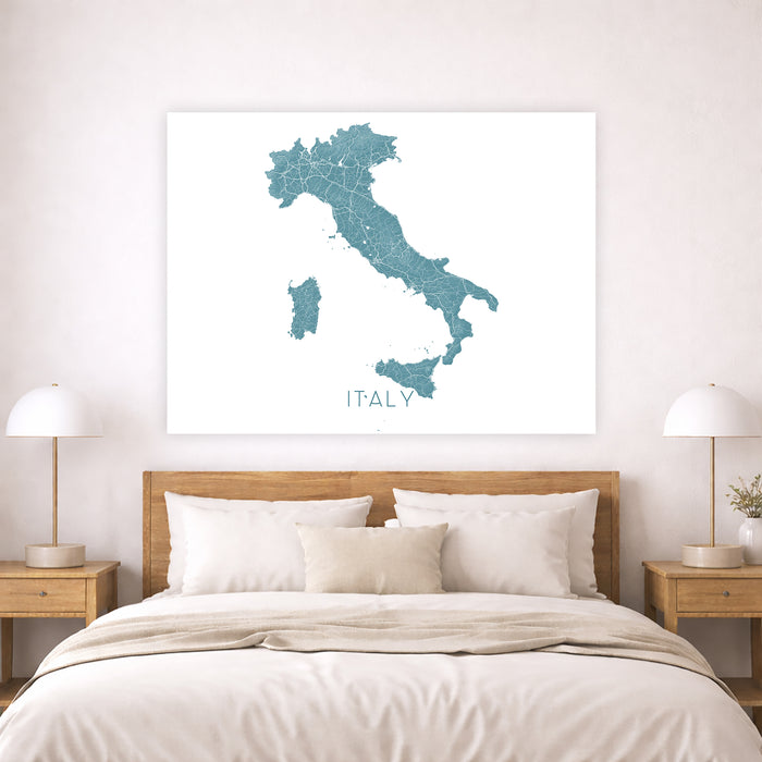 Map of Italy on a wall above a bed in a bedroom