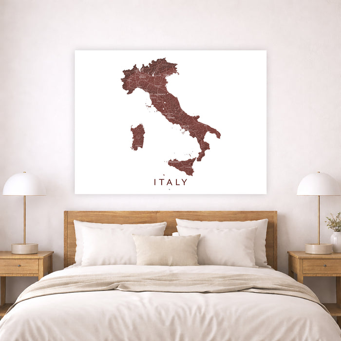 Map of Italy on a wall above a bed in a bedroom setting