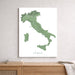 Map of Italy on a white wall above a wooden cabinet.