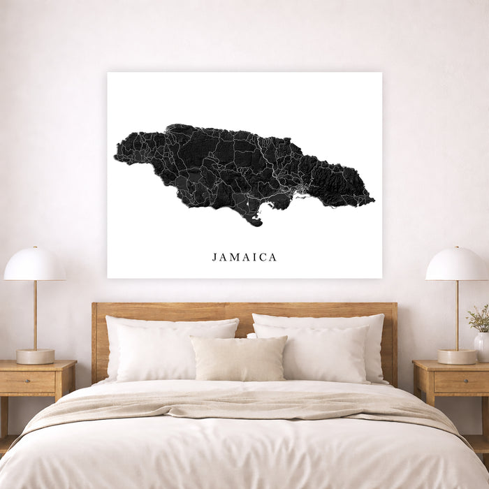Map of Jamaica on a wall above a bed in a bedroom setting