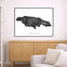 Framed map of Jamaica on a wall above a wooden cabinet and sofa.