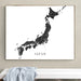 Framed map of Japan on a wall above a white bench.