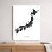 Map of Japan on a white wall above a wooden shelf.