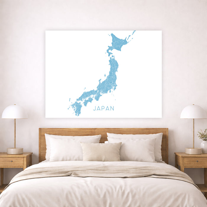 Map of Japan on a wall above a bed in a bedroom setting