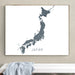 Framed map of Japan on a wall above a white bench.
