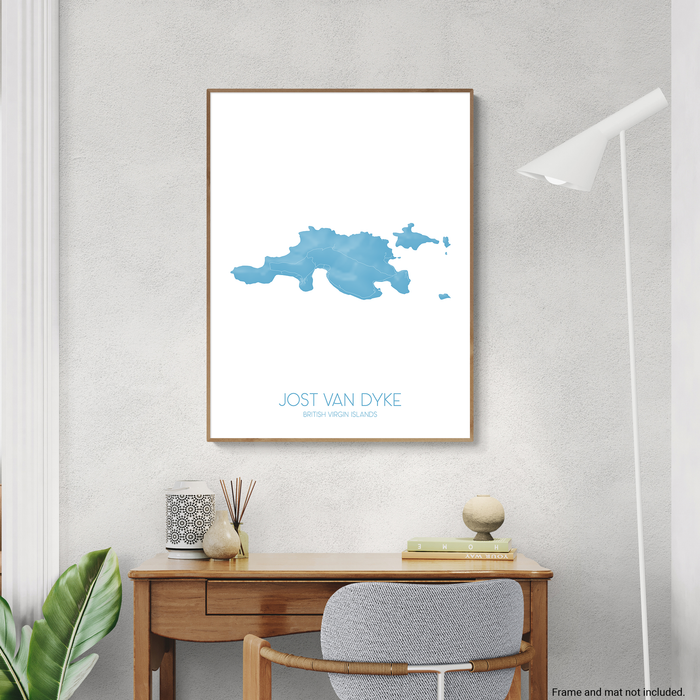 Framed map of Jost Van Dyke on a wall above a desk.