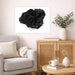 Framed black coral art print on a wall above a sofa in a living room.