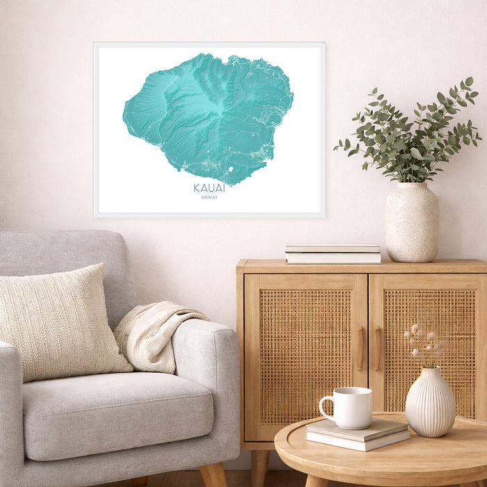 Living room with a map of Kauai on the wall, a vase with plants, and a coffee table with books and a mug.