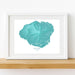 Framed map of Kauai, Hawaii on a white wall.