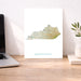 Map of Kentucky on a desk with a laptop and plant