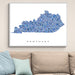 Framed map of Kentucky on a wall above a beige sofa with light blue pillows.
