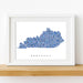 Framed map of Kentucky with blue pattern on a white background