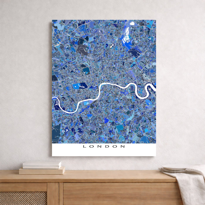 Map of London with blue mosaic pattern on a white wall above a wooden shelf.