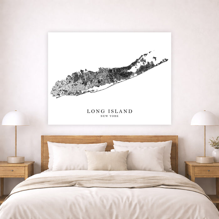 Framed map of Long Island, New York above a bed in a bedroom.