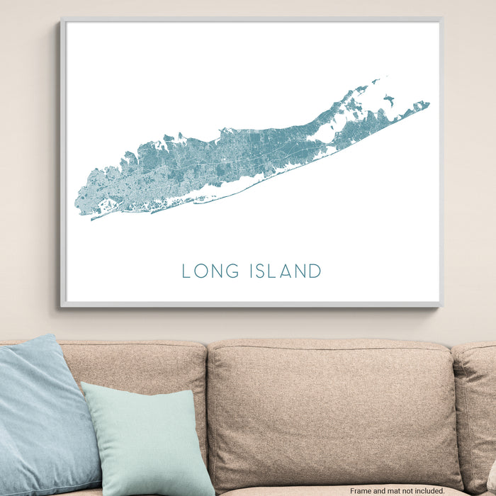 Framed map of Long Island on a wall above a beige sofa with light blue pillows.
