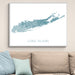 Framed map of Long Island on a wall above a beige sofa with light blue pillows.