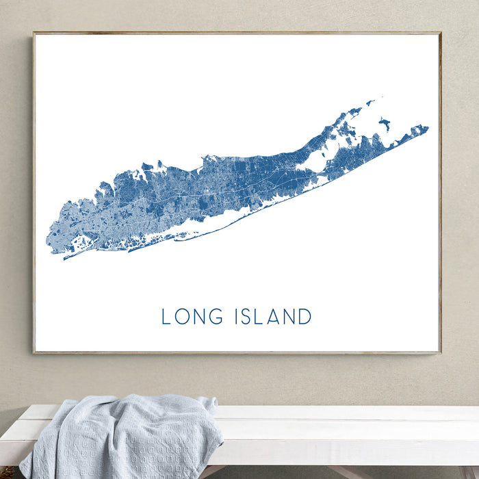 Framed map of Long Island on a wall above a bench.