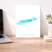 Print of 'Long Island' on a desk with a laptop and plant.