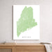 Map of Maine on a white background, framed above a wooden surface.