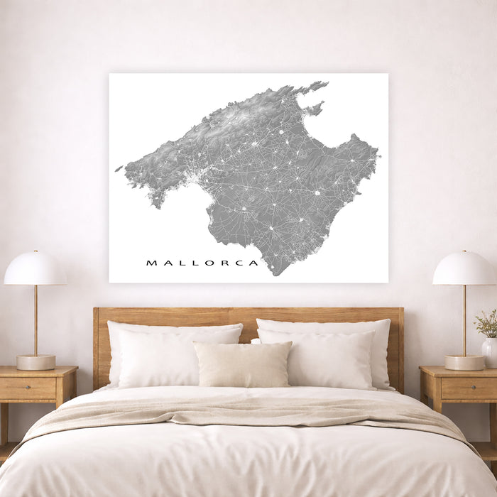 Map of Mallorca on a wall above a bed in a bedroom setting