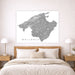 Map of Mallorca on a wall above a bed in a bedroom setting