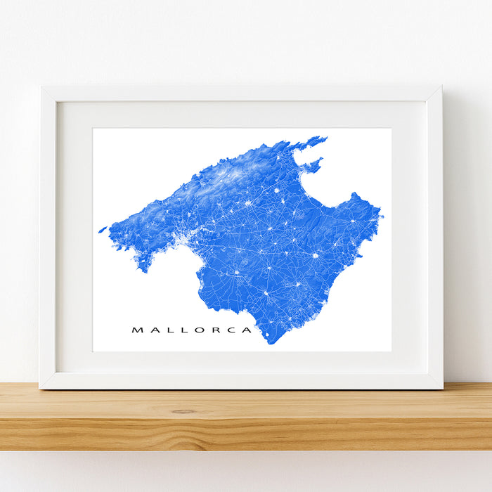 Framed map of Mallorca with a blue and white design on a white wall.