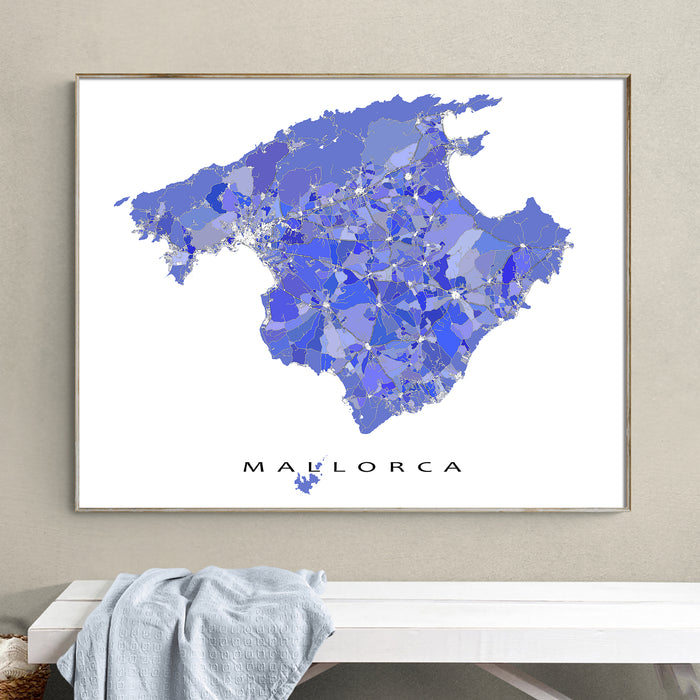 Framed map of Mallorca on a wall above a white bench.