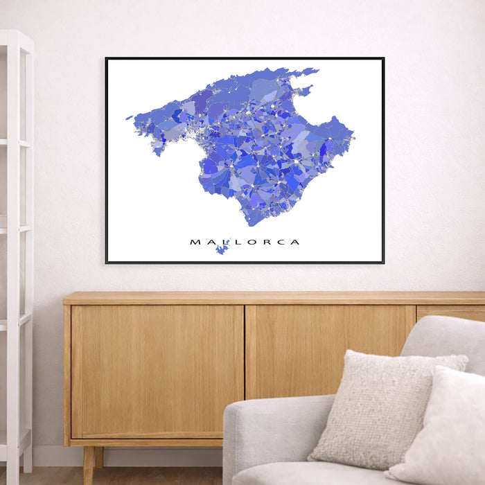 Map of Mallorca framed on a wall above a wooden cabinet and sofa.
