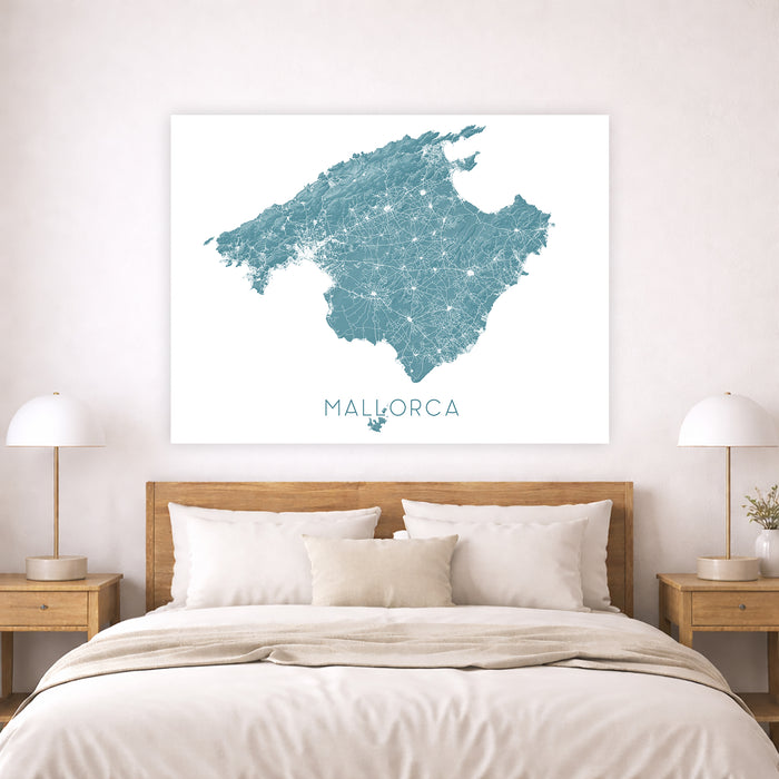 Map of Mallorca on a wall above a bed in a bedroom