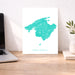 Map of Mallorca on a desk with a laptop and plant