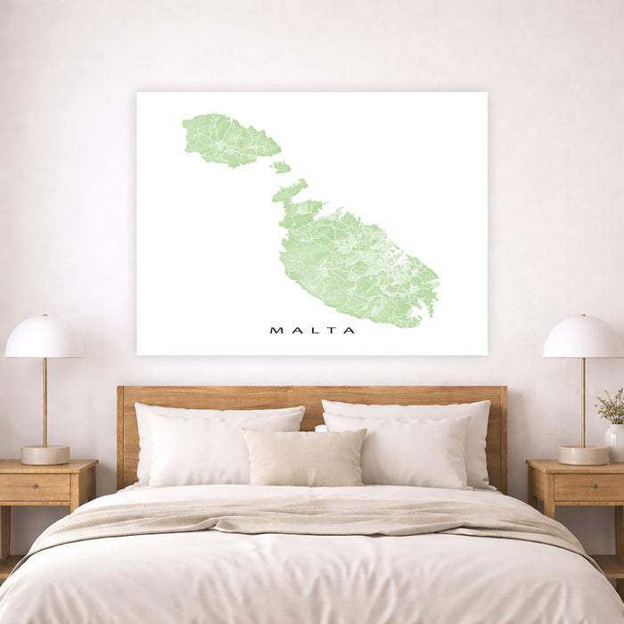 Map of Malta on a wall above a bed in a bedroom setting
