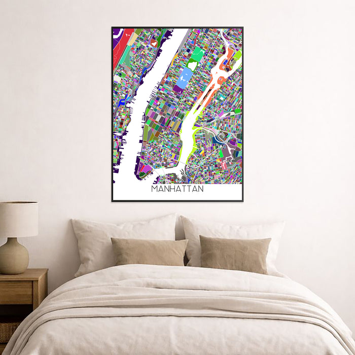 Colorful Manhattan map art print on a wall above a bed.