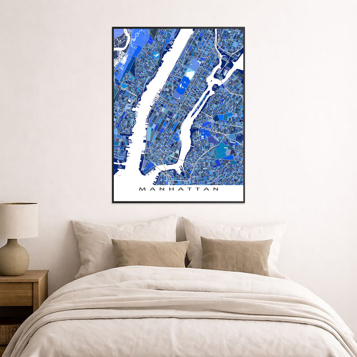 Framed map of Manhattan on a wall above a bed