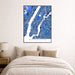 Framed map of Manhattan on a wall above a bed