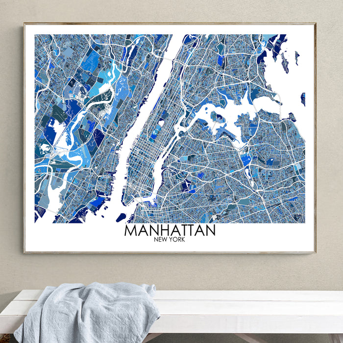 Framed map of Manhattan, New York on a wall above a white bench.