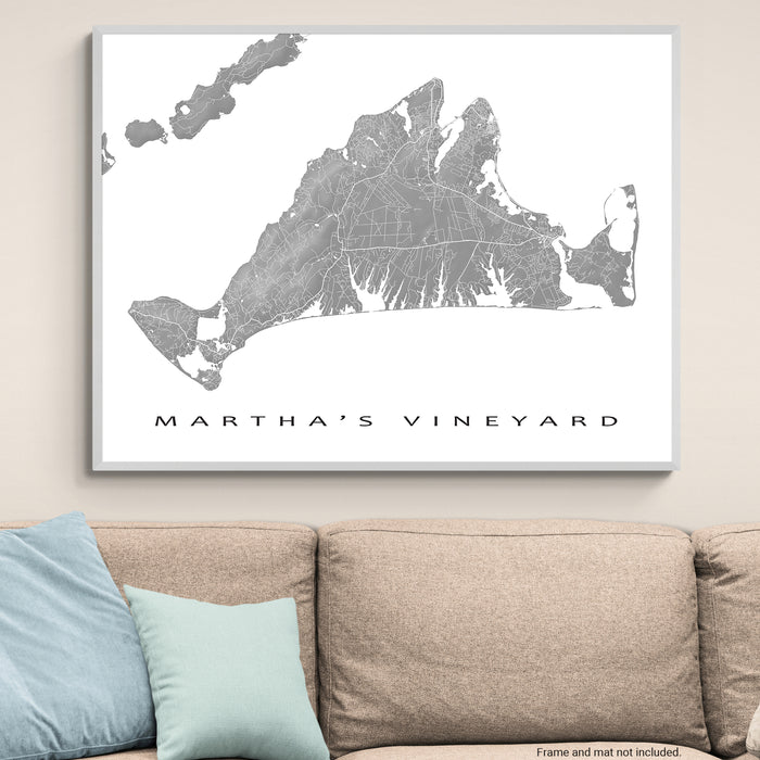 Framed map of Martha's Vineyard on a wall above a beige sofa with blue pillows.