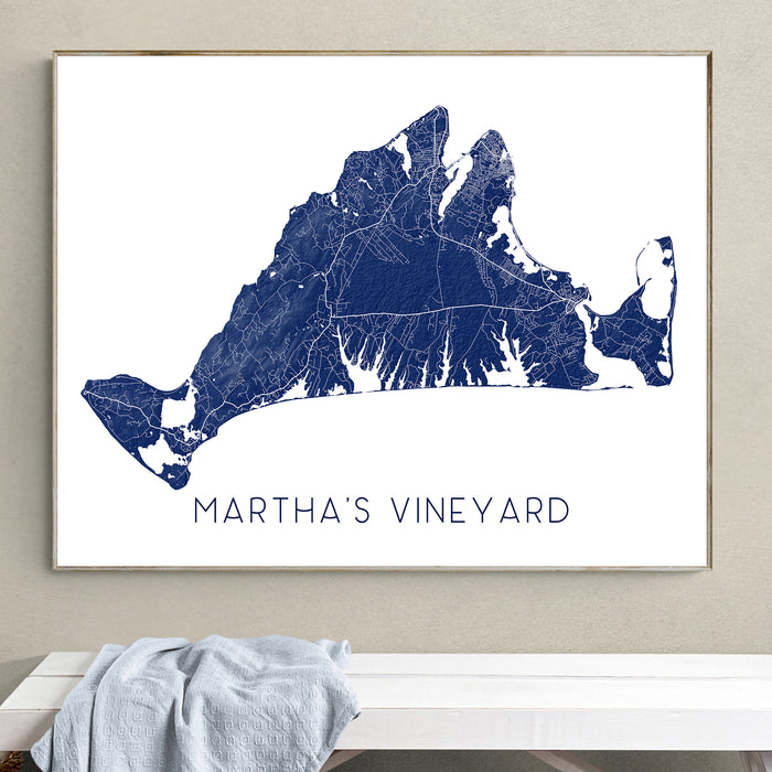 Framed map of Martha's Vineyard on a wall above a bench.