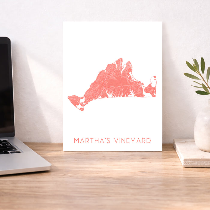 Map of Martha's Vineyard on a white background next to a laptop on a wooden desk.
