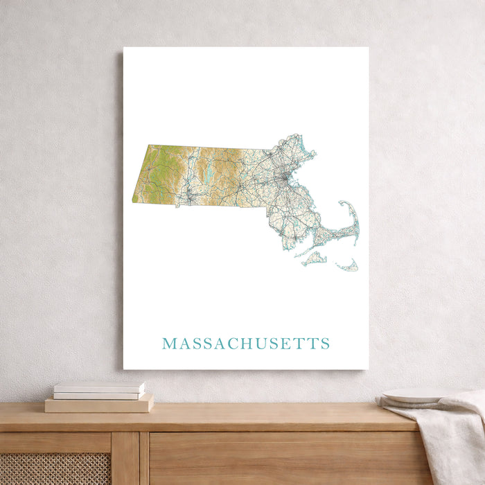 Map of Massachusetts on a white wall above a wooden shelf.