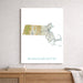 Map of Massachusetts on a white wall above a wooden shelf.