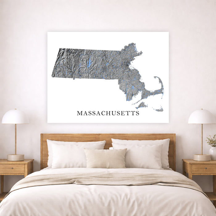 Map of Massachusetts on a wall above a bed in a bedroom setting