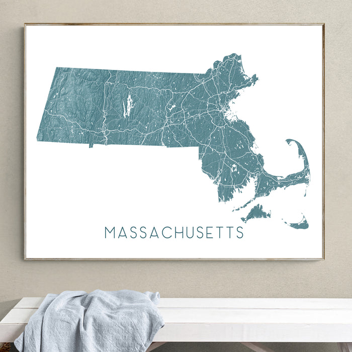 Framed map of Massachusetts on a wall above a white bench.